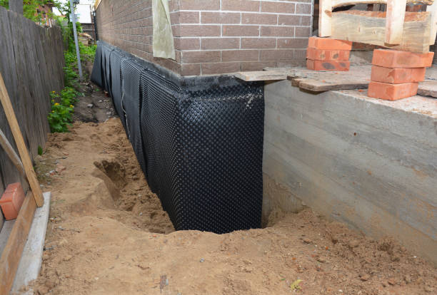 Happy homeowners after waterproofing job in Rogers